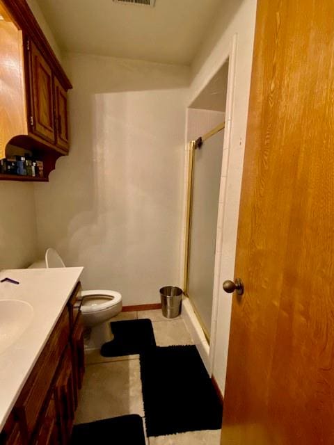 bathroom with vanity, toilet, and walk in shower