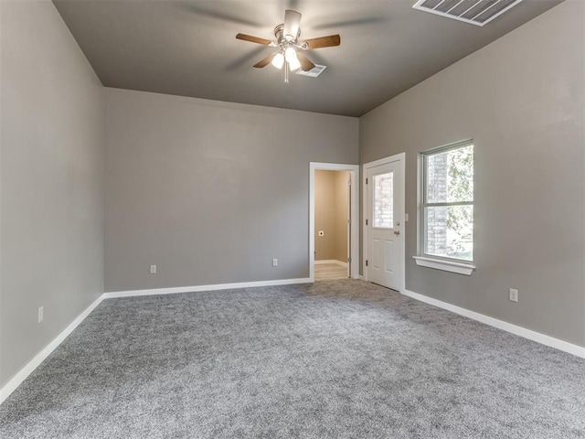 spare room featuring ceiling fan and carpet floors