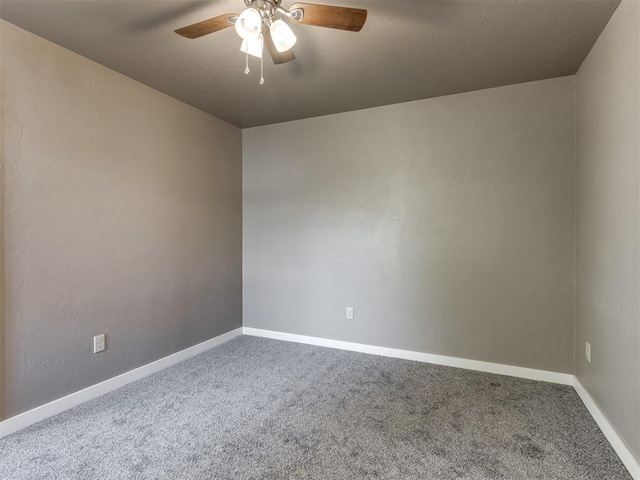 spare room featuring carpet flooring and ceiling fan