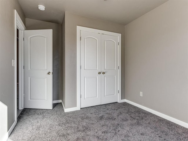 unfurnished bedroom with a closet and carpet