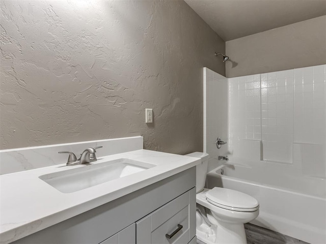 full bathroom with hardwood / wood-style flooring, toilet, vanity, and tub / shower combination