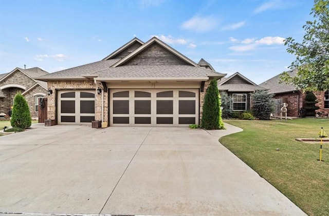 view of front of property with a front yard and a garage