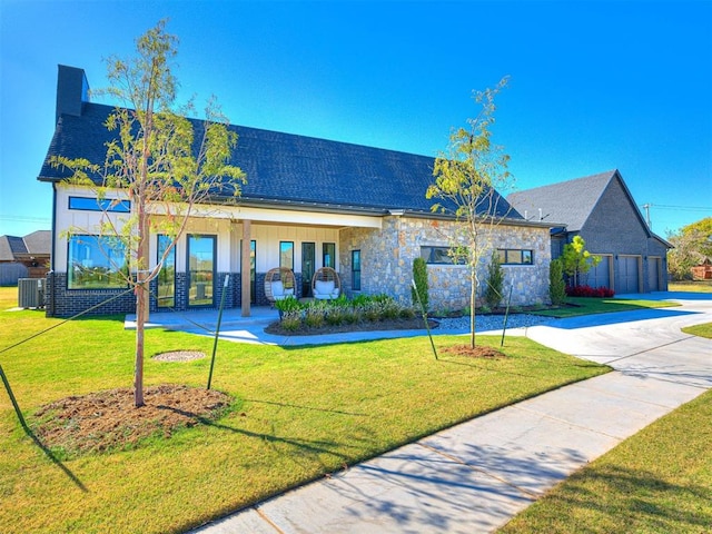 view of front of home featuring covered porch, central AC unit, and a front lawn