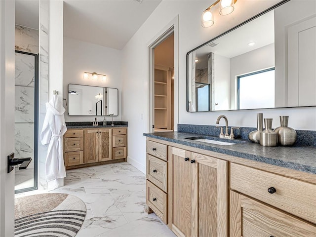 bathroom featuring vanity and a shower with shower door