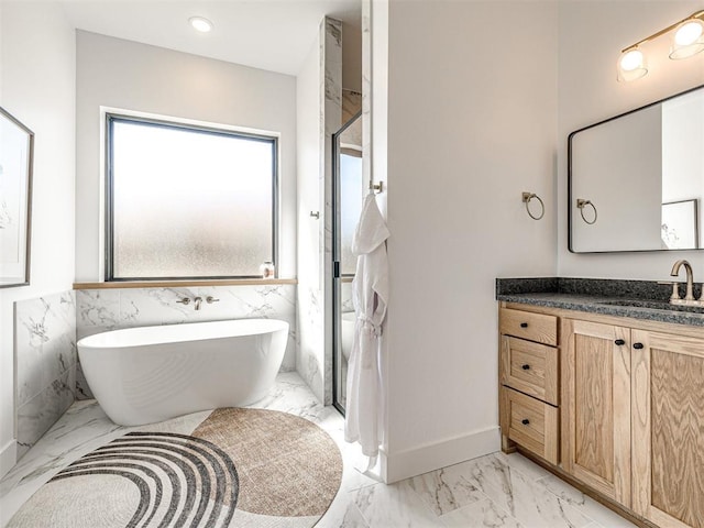 bathroom featuring vanity, separate shower and tub, and tile walls