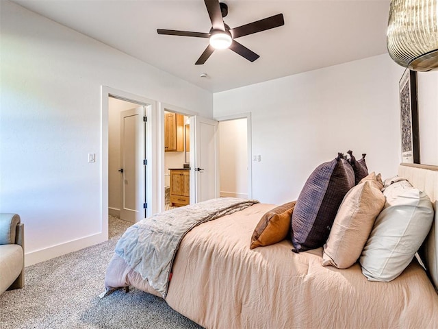 bedroom with light colored carpet, ceiling fan, and ensuite bathroom