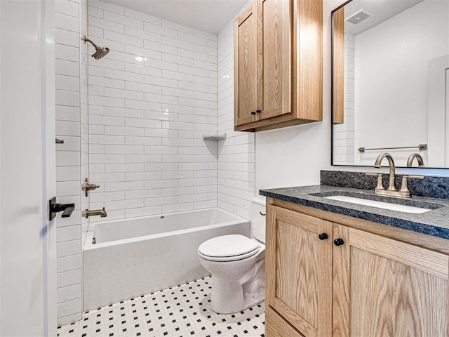 full bathroom featuring tile patterned flooring, vanity, toilet, and tiled shower / bath