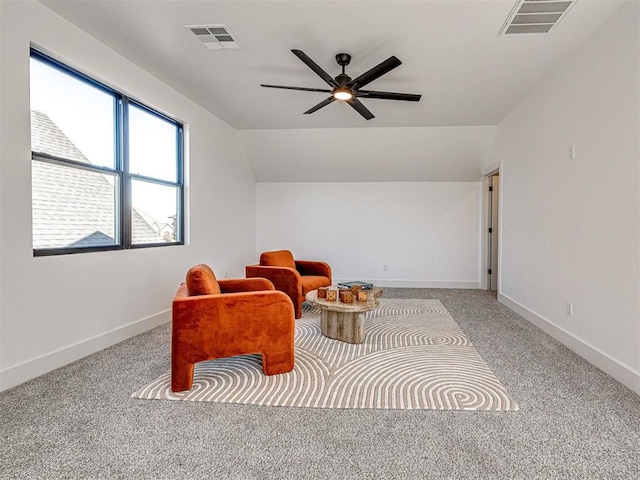 sitting room with ceiling fan, light colored carpet, and lofted ceiling