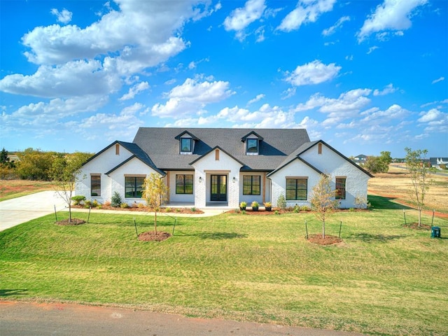 modern inspired farmhouse with a front lawn