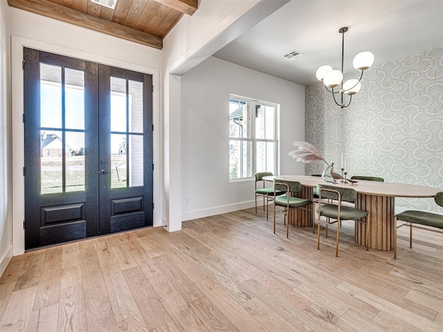 entrance foyer featuring wooden ceiling, french doors, light hardwood / wood-style flooring, beam ceiling, and a chandelier