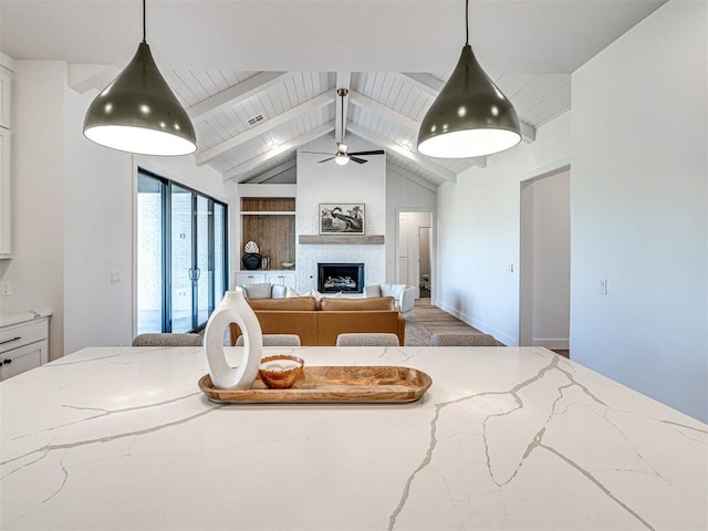 interior space featuring vaulted ceiling with beams, a large fireplace, and wood ceiling