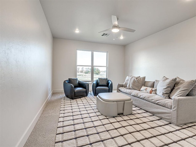 carpeted living room featuring ceiling fan