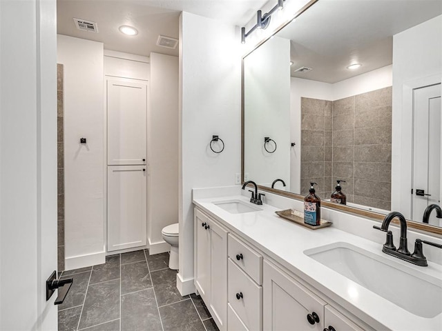 bathroom featuring tile patterned floors, vanity, and toilet