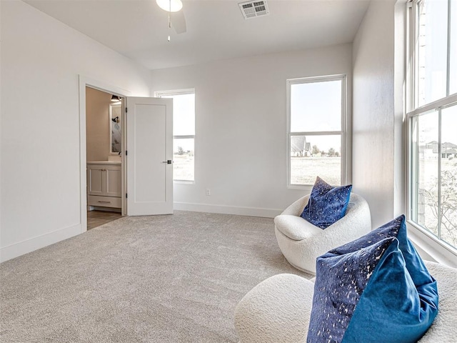 sitting room with ceiling fan and carpet floors