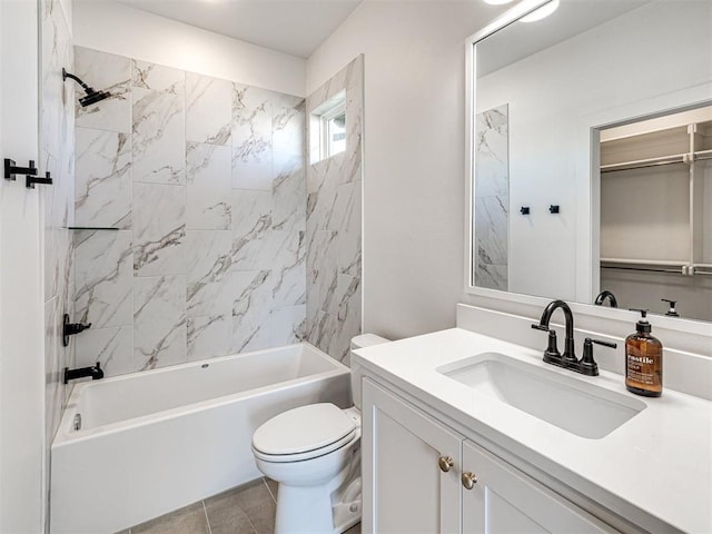 full bathroom featuring tile patterned flooring, vanity, tiled shower / bath combo, and toilet