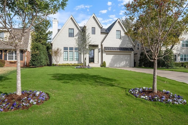 view of front of property featuring a garage and a front lawn