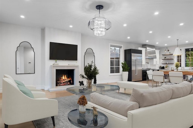 living room featuring light hardwood / wood-style flooring and a chandelier