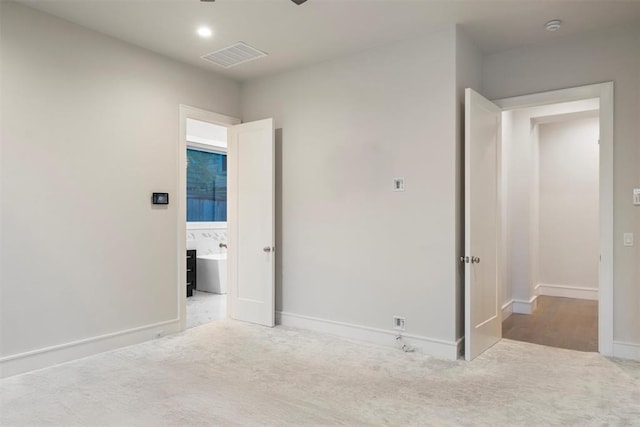 unfurnished bedroom with light colored carpet