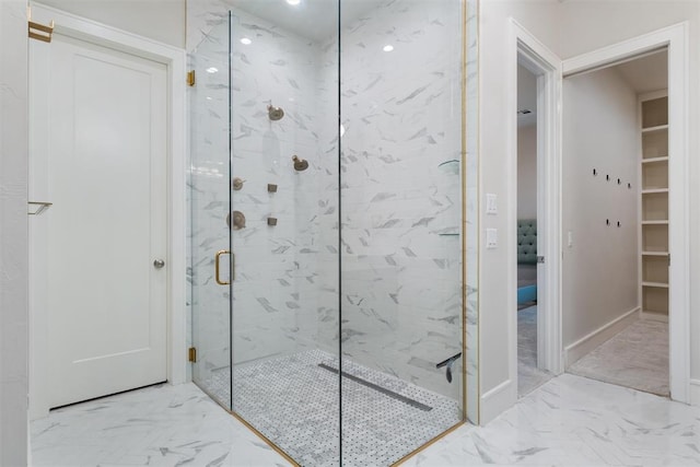 bathroom featuring a shower with shower door