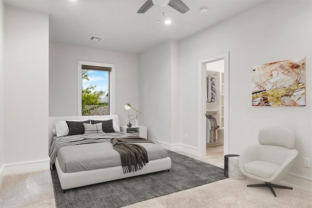 bedroom with carpet flooring, ensuite bathroom, and ceiling fan