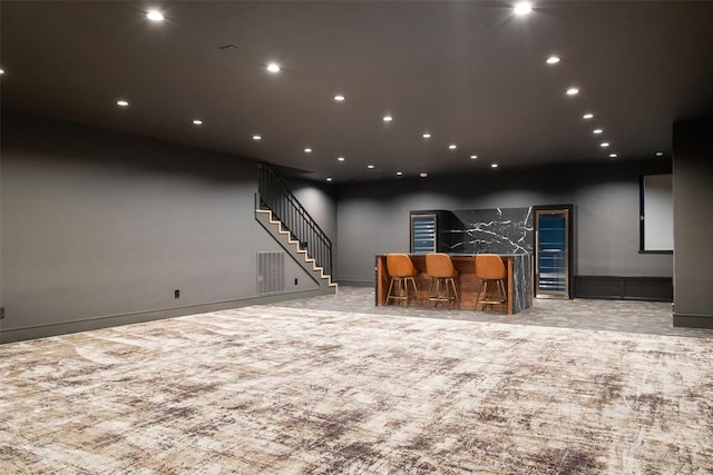 interior space featuring light colored carpet and indoor bar