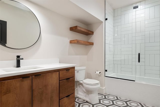 full bathroom with vanity, bath / shower combo with glass door, and toilet