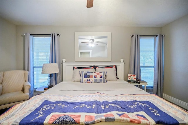 bedroom featuring baseboards, multiple windows, and a ceiling fan