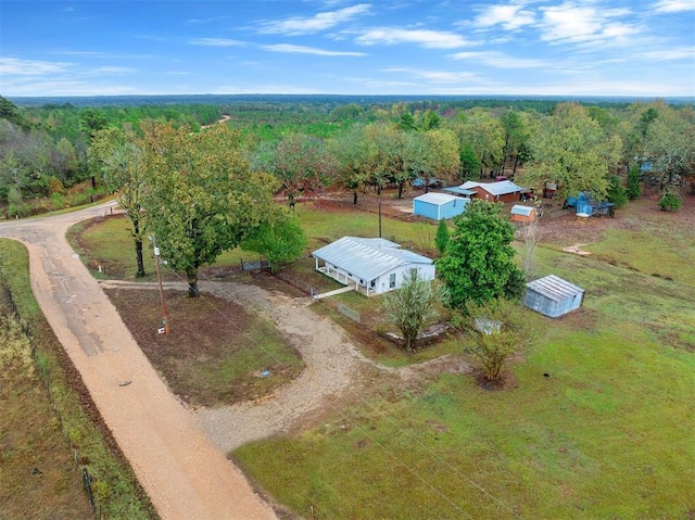drone / aerial view with a wooded view