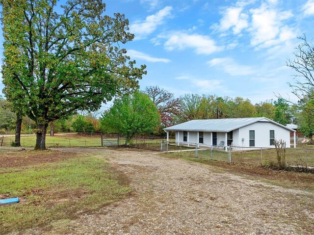 view of yard featuring driveway and fence