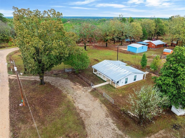 birds eye view of property featuring a view of trees