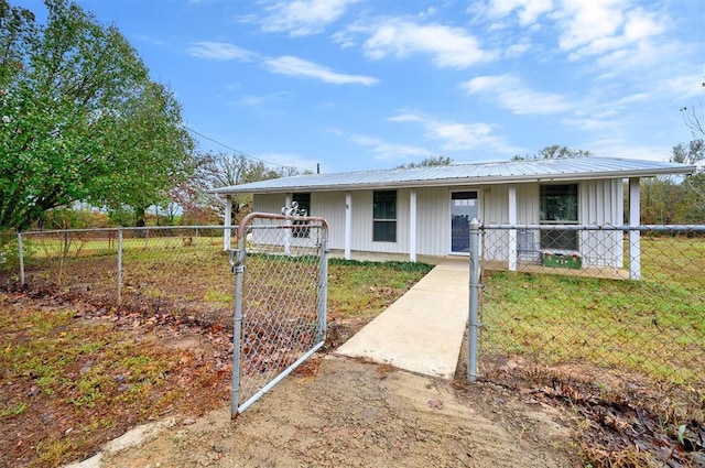 view of front of home featuring a porch, a gate, fence, and metal roof