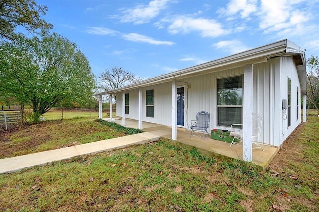ranch-style home with a front yard and fence