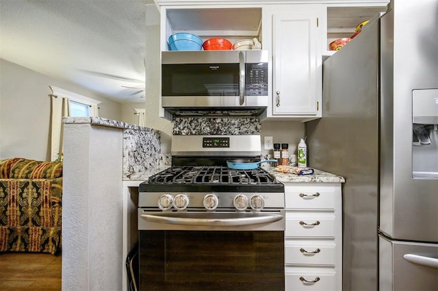 kitchen with white cabinets and appliances with stainless steel finishes