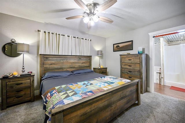bedroom featuring a ceiling fan, carpet floors, and a textured ceiling