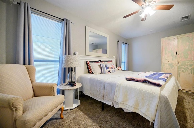carpeted bedroom with visible vents and ceiling fan