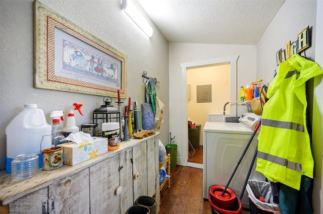 washroom featuring electric panel, separate washer and dryer, a textured ceiling, dark wood finished floors, and laundry area