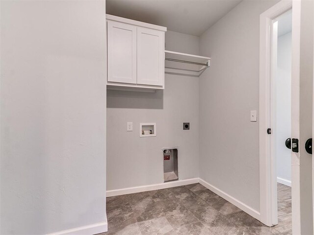 washroom with hookup for a washing machine, cabinets, and hookup for an electric dryer