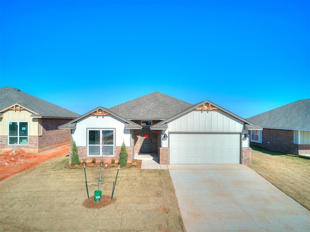 view of front of home featuring a garage and a front lawn