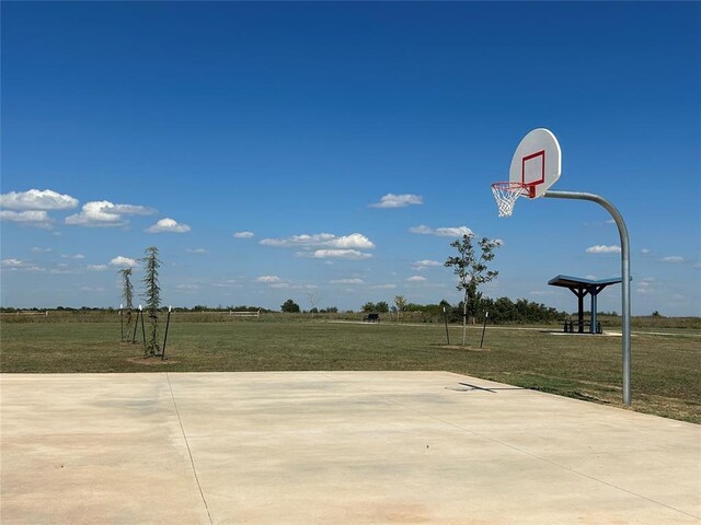 view of sport court with a yard