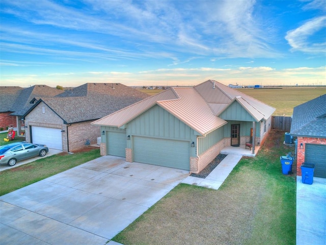 view of front of house with a front yard and a garage