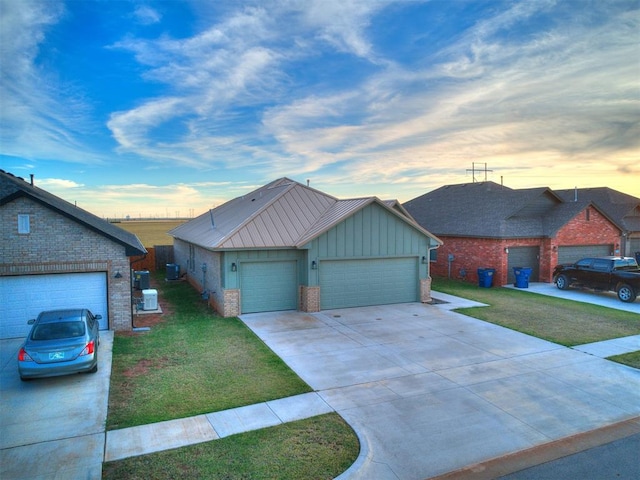 ranch-style home featuring a garage and a lawn