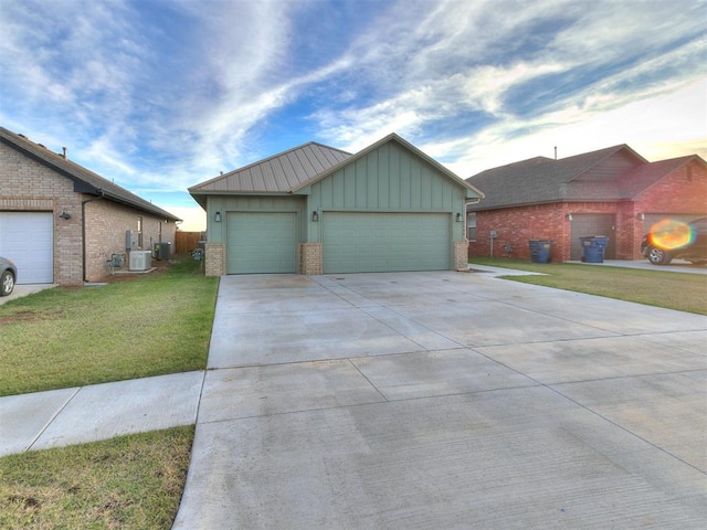 view of front of home with ac unit, a front lawn, and a garage