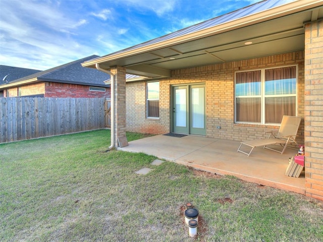 back of property featuring a yard and a patio area