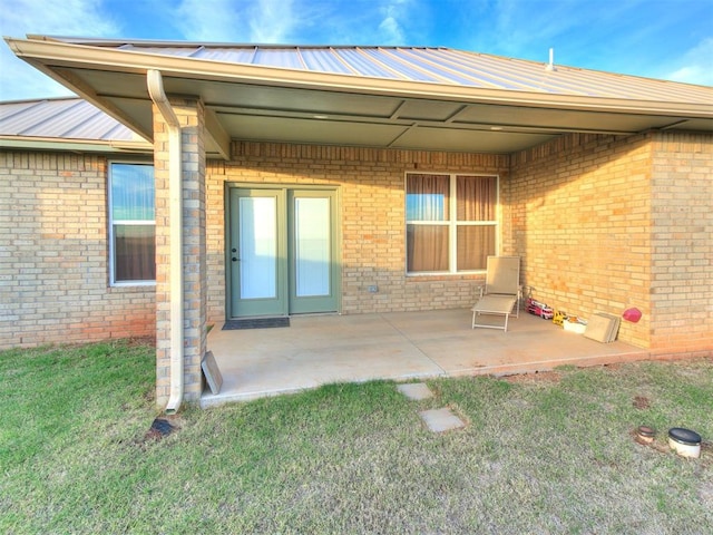 rear view of property with a yard and a patio