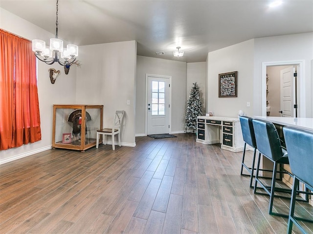 foyer entrance featuring hardwood / wood-style floors and a notable chandelier