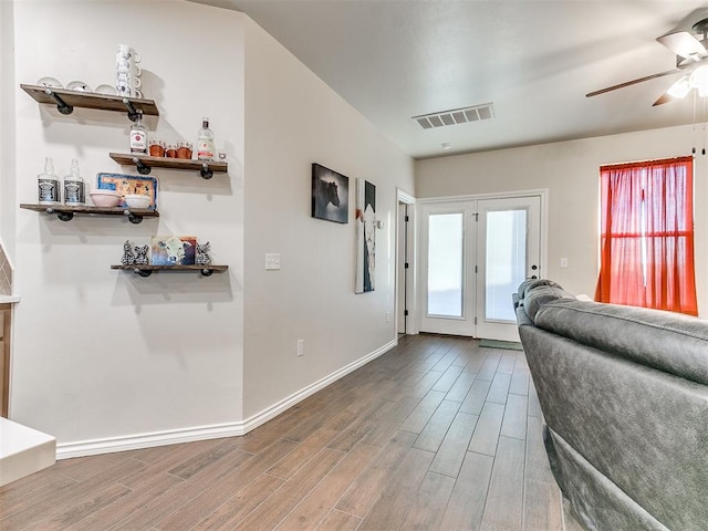 interior space featuring bar area, ceiling fan, and hardwood / wood-style floors