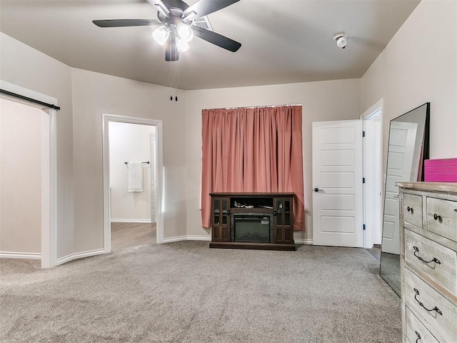 unfurnished living room featuring light carpet and ceiling fan