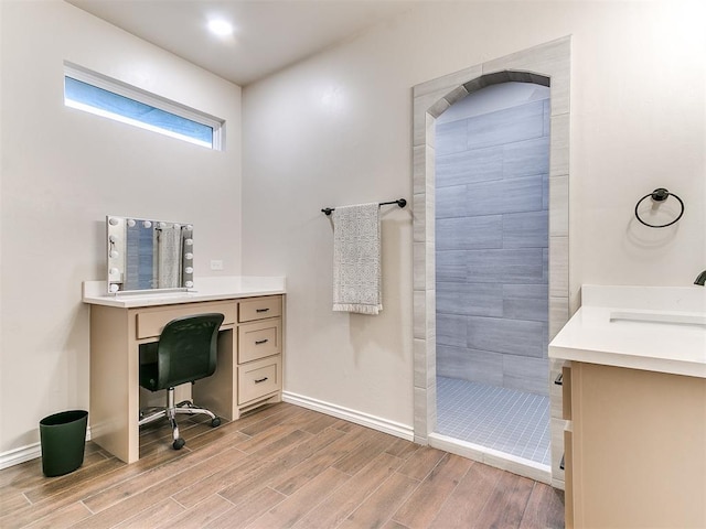 bathroom featuring a shower, vanity, and wood-type flooring