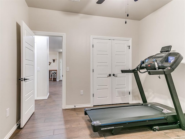 workout area featuring hardwood / wood-style flooring and ceiling fan