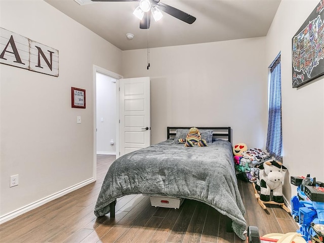 bedroom with ceiling fan and hardwood / wood-style flooring